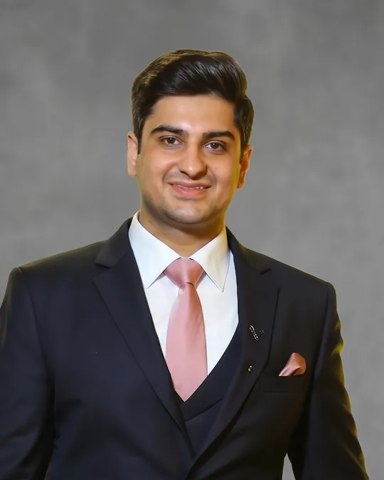 CA Mayannk Chuchrra, Wise Bucks mentor, in a dark suit against a grey backdrop