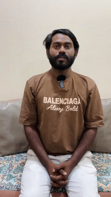 Suresh, a Wise Bucks student in a brown T-shirt, speaking to the camera