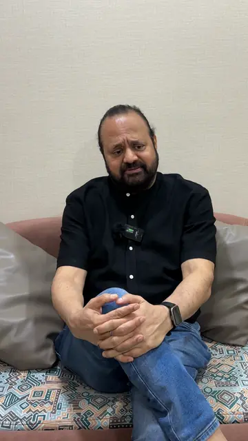 R.K. Gupta, a Wise Bucks student in a black shirt, speaking to the camera